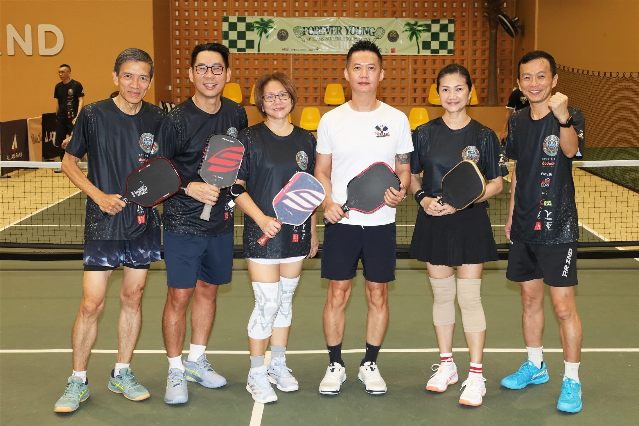 A Forever Young team posing together with their paddles