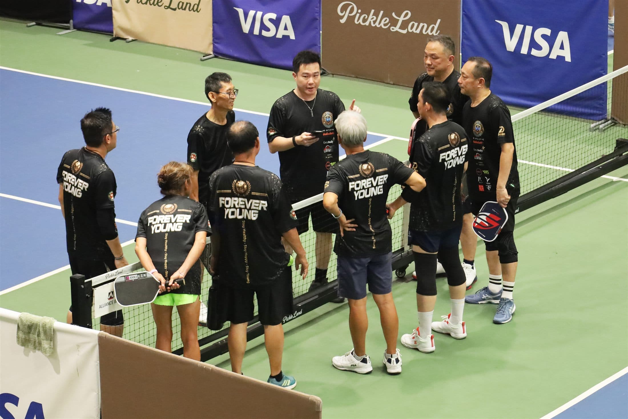 A Forever Young team huddled at the net