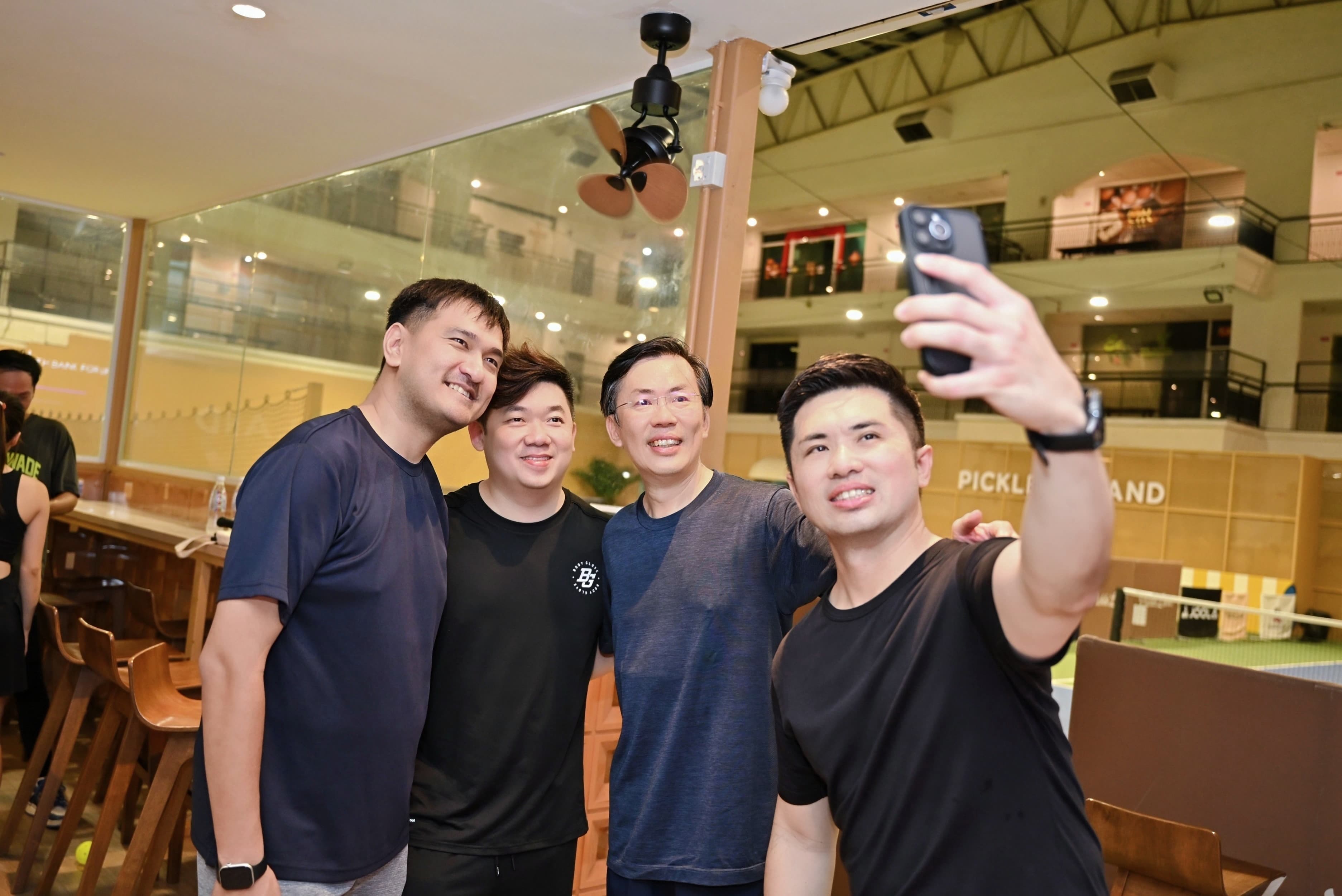 CEO Sports Club guests taking a selfie beside the courts