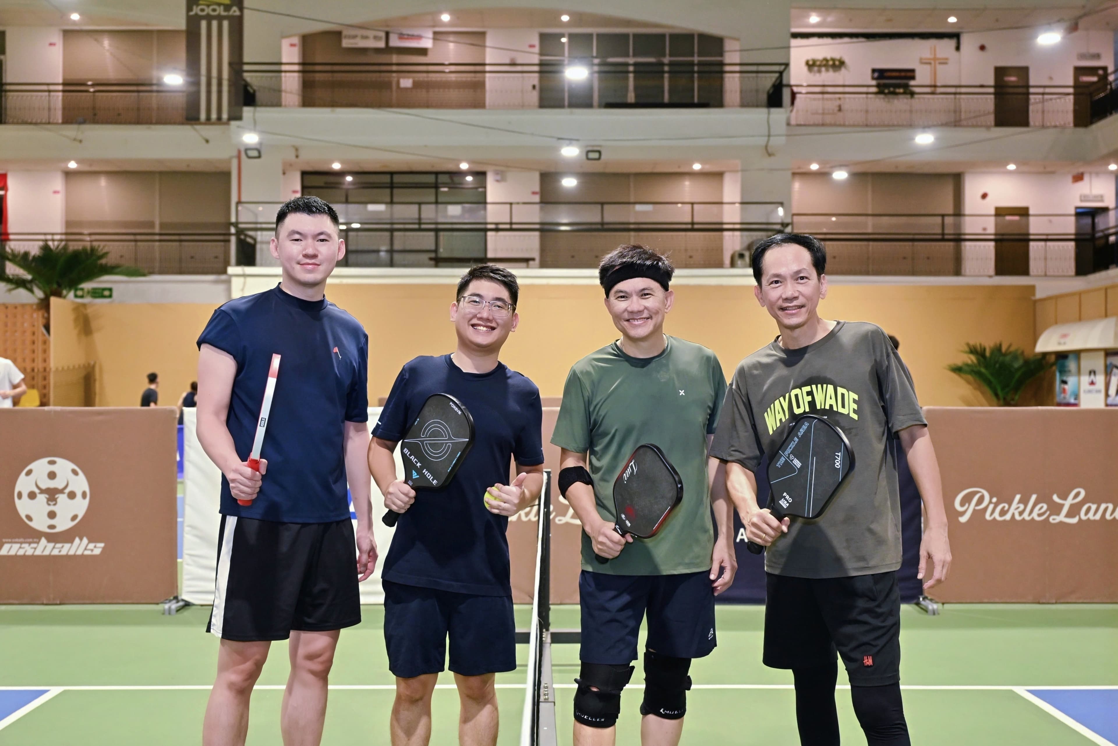Four CEO Sports Club players posing by the net